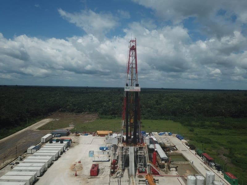 The Oyebisi A-001 rig mast against a storm cloud at Atamba